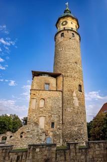 Stone wall and tower with old ruins under a blue, cloudy sky, The Niedeck Ruins in Arnstadt