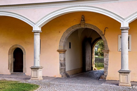Close-up of an archway of a historic building with paved floor, gate to the district office in the