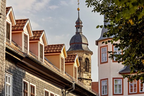 Church tower with traditional roofs and gables in an old town at sunset, The old town of Arnstadt