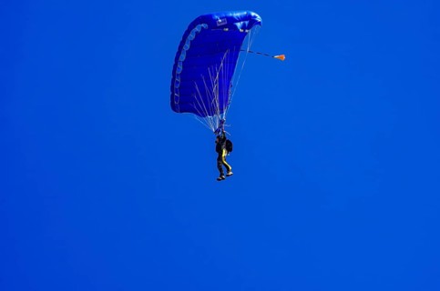 Skydivers during an aerial acrobatic performance as part of an air show at the Fliegerbergfest of