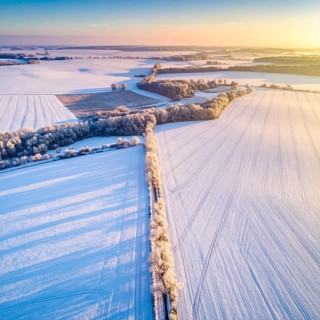 Bird Eye Perspective of Frost Covered Farmland. Seasonal Agricultural Scenery, winter and autumn