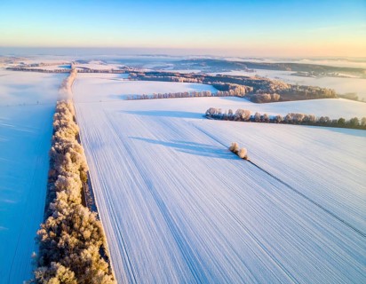 Bird Eye Perspective of Frost Covered Farmland. Seasonal Agricultural Scenery, winter and autumn