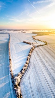 Bird Eye Perspective of Frost Covered Farmland. Seasonal Agricultural Scenery, winter and autumn