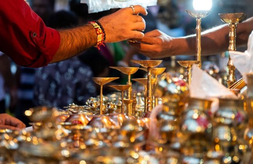 People shop for bronze and other metal items at a roadside stall on Dhanteras, in Guwahati, Assam,