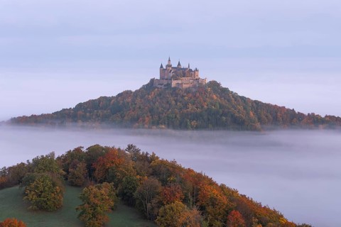 Hohenzollern Castle in a sea of fog at sunrise, autumn in the Swabian Jura