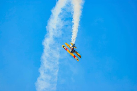 A Boeing-Stearman biplane during a flight demonstration as part of an air show at the Rossfeld in