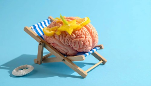 Brain relaxes on a sunbed under the summer sun, placed on a flat surface, symbol for mental health,