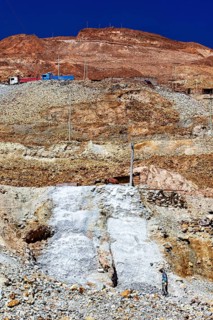 Sky over a stony mountain with barren earth and visible power lines, The silver mines of Potosi
