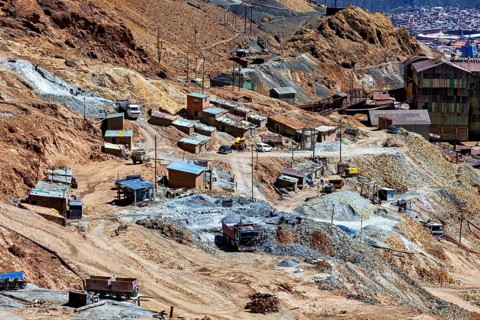 Mining area with scattered huts and lorries in an impassable terrain, The silver mines of Potosi