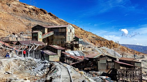 Historic industrial site on a mountainside under a clear blue sky, The silver mines of Potosi