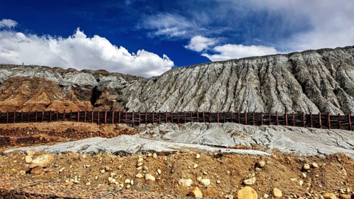 Rocky mountain formation with a contrast between barren slopes and blue sky, spoil heap of the