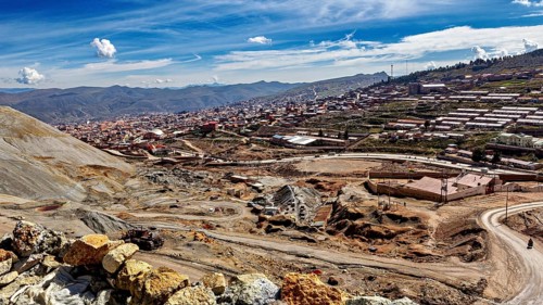 View of a town along a mountainous landscape under a clear blue sky with few clouds, The silver
