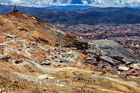 Far-reaching panorama of a city embedded in a mountainous landscape with clouds, The silver mines