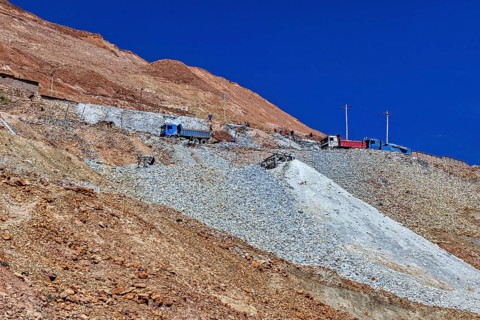 Lorries parked on the slope of a rocky mountain under a clear blue sky, The silver mines of the