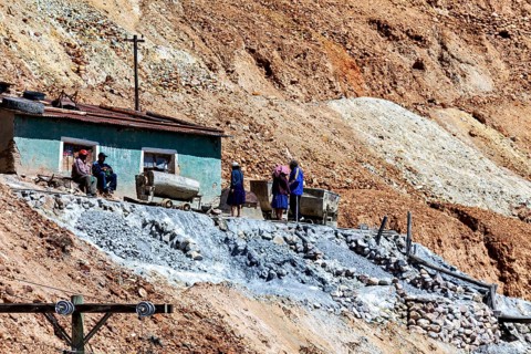 Miners with wheelbarrows on a rocky slope during mining work, The silver mines of Potosi Bolivia