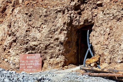 Mine entrance with shield and metallic beams in a rocky environment, The silver mines of Potosi