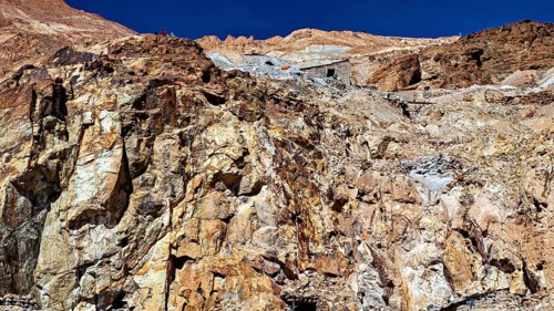 Textured rock face on a mountainside under a clear blue sky, The silver mines of Potosi Bolivia