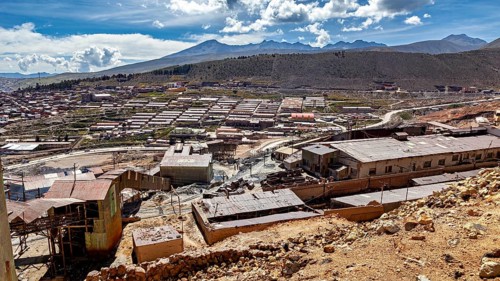 Sweeping views of a valley surrounded by mountains and scattered buildings, The silver mines of