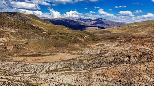 Wide valley in a mountainous region with sparse vegetation, The landscape of the Altiplano in