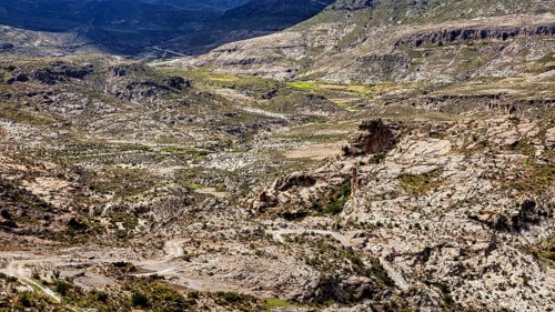Steep mountain and valley formations in an arid landscape with barren rocks, The landscape of the