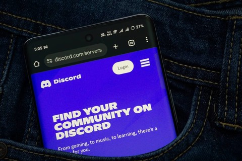 Dhaka, Bangladesh- 03 Oct 2025: A smartphone displaying the Discord web interface peeks out of a