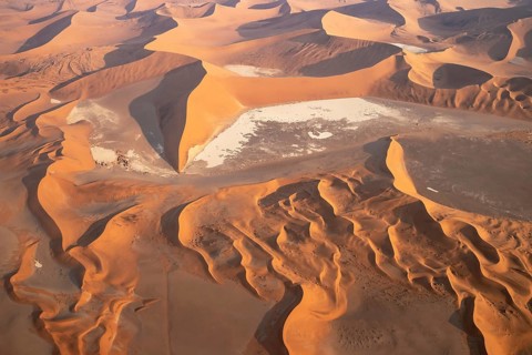 Sand dunes and dry pans in the Namib Desert. In the evening. Aerial view. Namib-Naukluft Park,