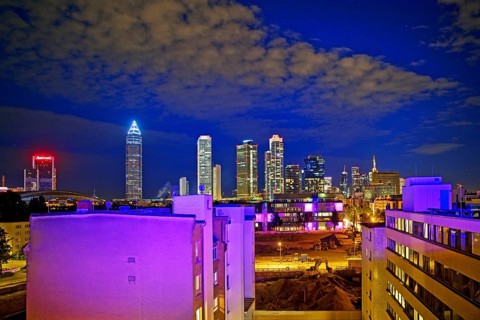 Rooftop day with colourfully illuminated houses for a techno party on the roof with a view of the