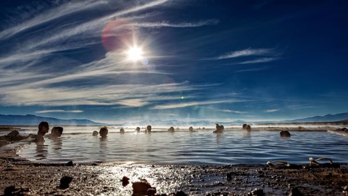 Sunrays over people in hot springs, surrounded by nature, The thermal springs of Polques in Bolivia
