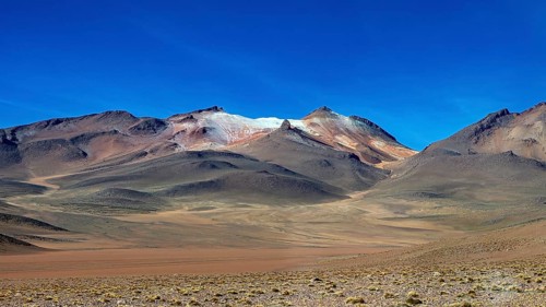 Rocky mountains under a deep blue sky in an arid region, The landscape with the volcanoes on the
