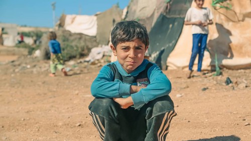 Syrian children playing in a refugee camp near the Turkish border on World Children's Day. Aleppo,