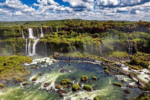 Expansive aerial view over river landscape with waterfalls and dense forest, The Iguazu Falls