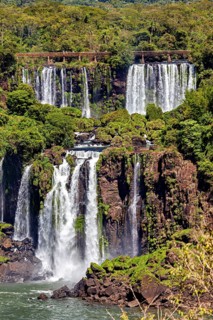 Dramatic waterfalls in the middle of the jungle, surrounded by rocks and lush flora, The Iguazu