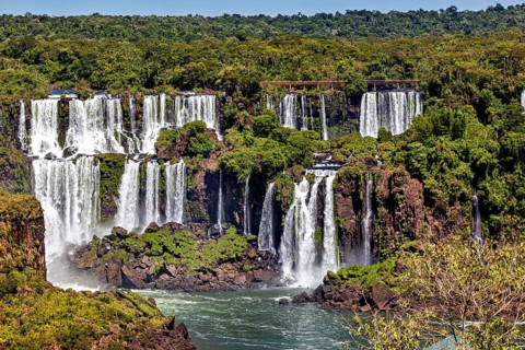Extensive water landscape with numerous cascades, framed by dense forest, The Iguazu Falls between