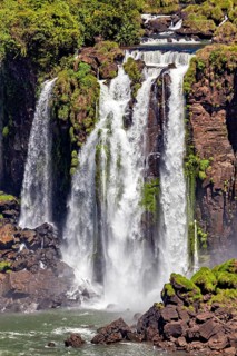 Close-up of impressive waterfalls cascading over moss-covered rocks, The Iguazu Falls between