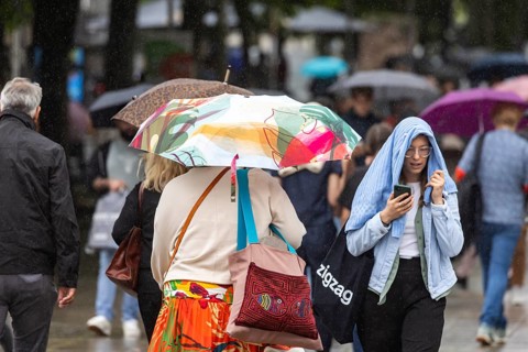Rainy weather in Stuttgart. People with umbrellas hurry through the rain on Königstraße. Stuttgart,