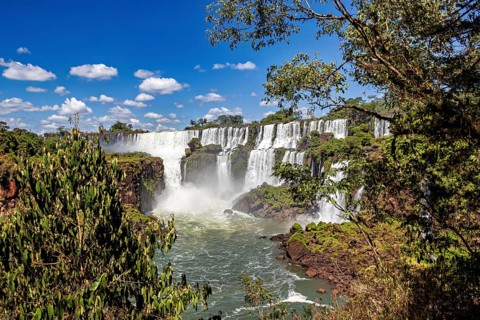 Waterfalls in the heart of the jungle under a clear sky, The Iguazu Falls between Argentina and