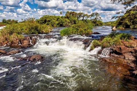 Tranquil river landscape with rapids and surrounding vegetation, the Iguazu waterfalls between
