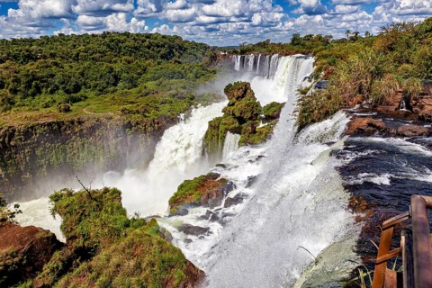 Impressive waterfall with adjoining wooden walkway and dense vegetation, The Iguazu Falls between