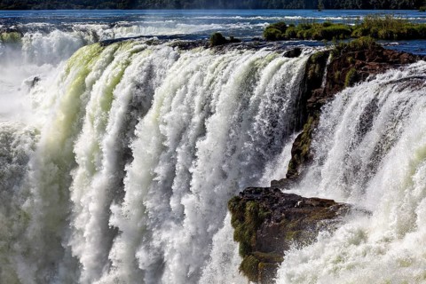 Mighty waterfall with cascading masses of water and swirling spray, The Iguazu Falls between