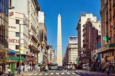 A busy street scene in daylight in Buenos Aires with the obelisk in the centre, The great obelisk