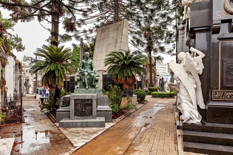 Ornate tomb with statues and angels in a peaceful setting, La Recoleta cemetery in Buenos Aires