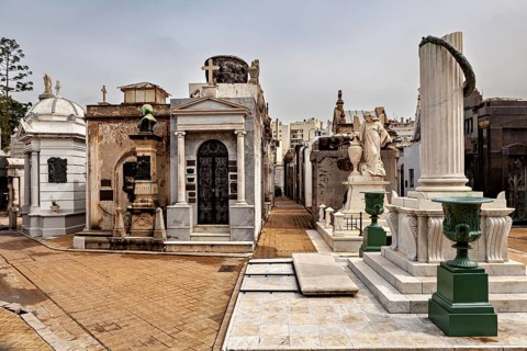 Row of marble monuments and columns in a historic cemetery, La Recoleta Cemetery in Buenos Aires