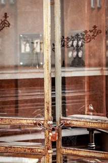Old rusted metal gate with chain and padlock in an urban environment, La Recoleta cemetery in