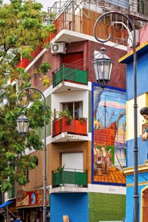 Colourful building with balconies and murals in a lively neighbourhood, the colourful city and