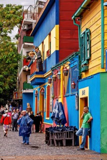People stroll in front of colourful buildings with a dynamic, lively atmosphere, The colourful city