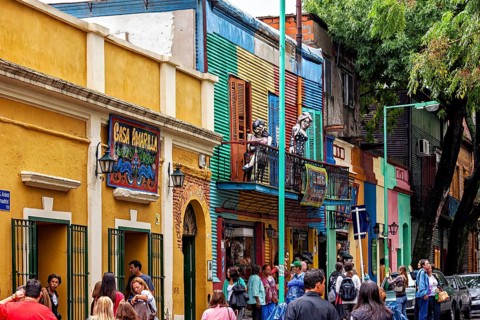 Lively street with colourful buildings and passers-by in La Boca, Buenos Aires, The colourful city