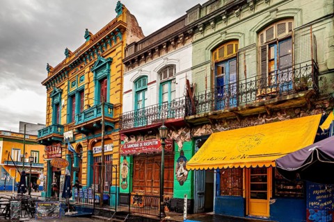 Traditional colourful facades along a cloudy street backdrop, The colourful city and tango district