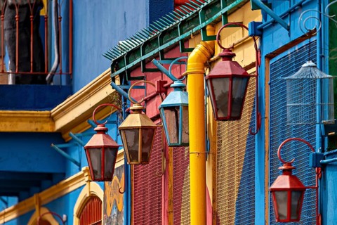 Detailed view of colourful lanterns in front of vividly painted facades, The colourful city and