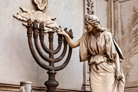Stone statue of a woman touching a candlestick, artistic and detailed, La Recoleta cemetery in