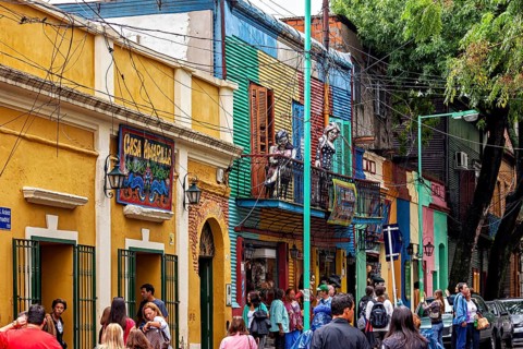 Lively street view with sculptures and colourful buildings in La Boca, the colourful city and tango